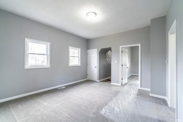 unfurnished bedroom with light carpet