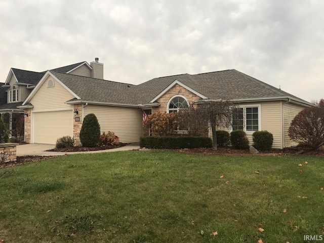 ranch-style home with a garage and a front lawn