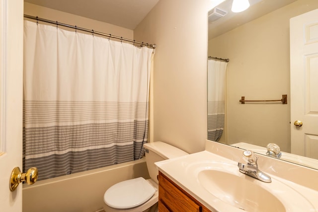 full bathroom featuring shower / bath combo, vanity, and toilet