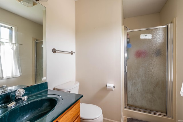 bathroom with vanity, toilet, and walk in shower