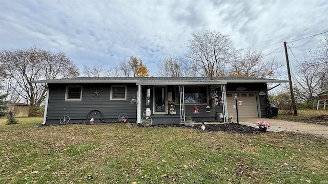 view of front of property with a garage and a front lawn