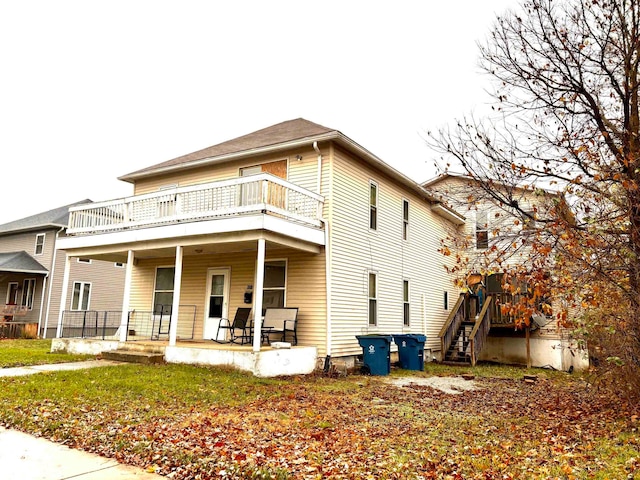 view of front of property featuring a porch and a balcony