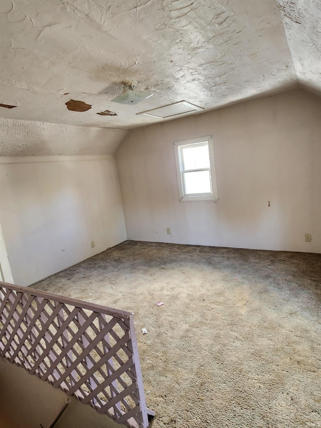 bonus room featuring lofted ceiling, a textured ceiling, and carpet floors