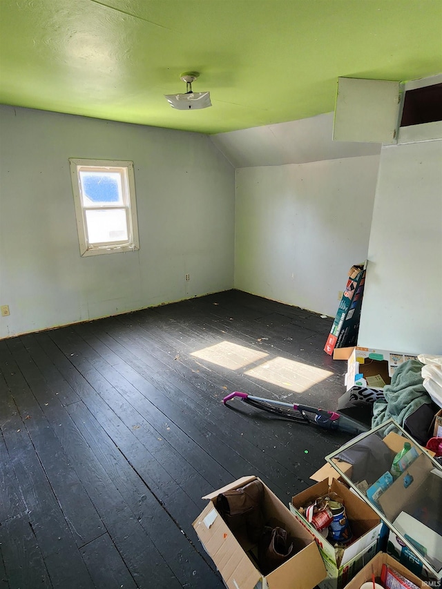 empty room featuring dark hardwood / wood-style floors and lofted ceiling