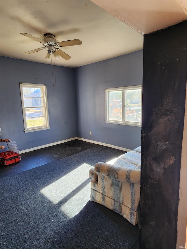 carpeted bedroom with multiple windows and ceiling fan