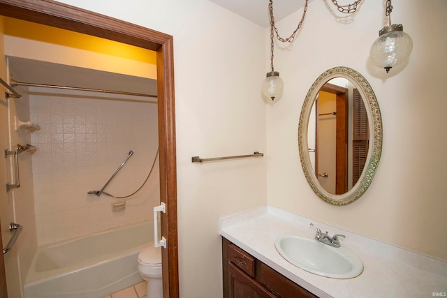 full bathroom with tile patterned floors, vanity, tiled shower / bath, and toilet