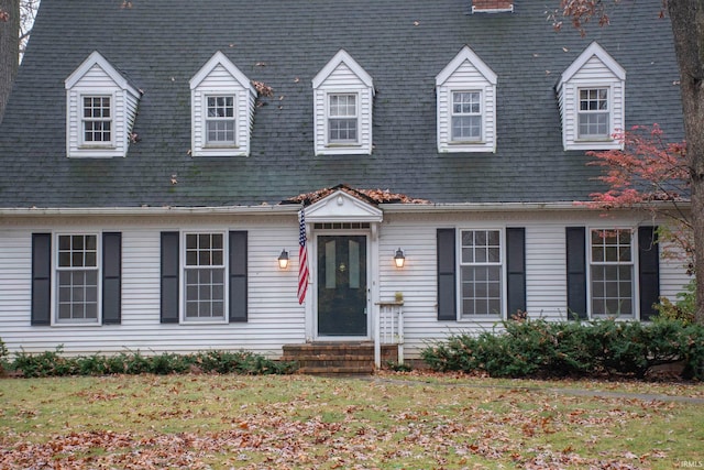 new england style home with a front lawn