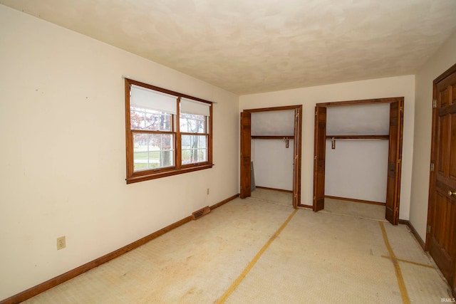 unfurnished bedroom featuring light carpet