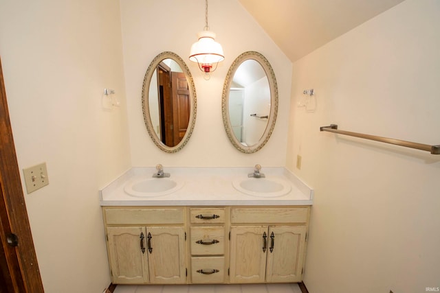 bathroom featuring vanity and lofted ceiling