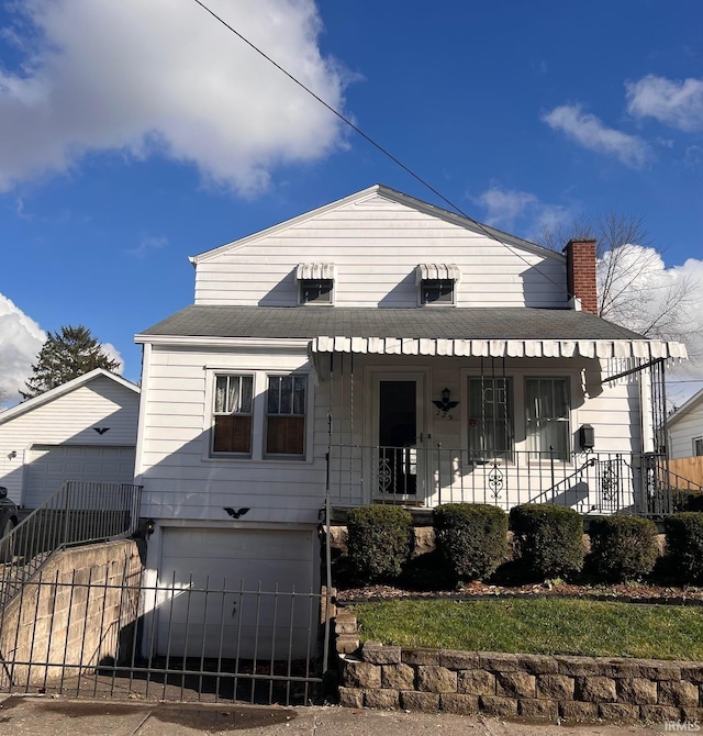 view of front of home with a porch and a garage