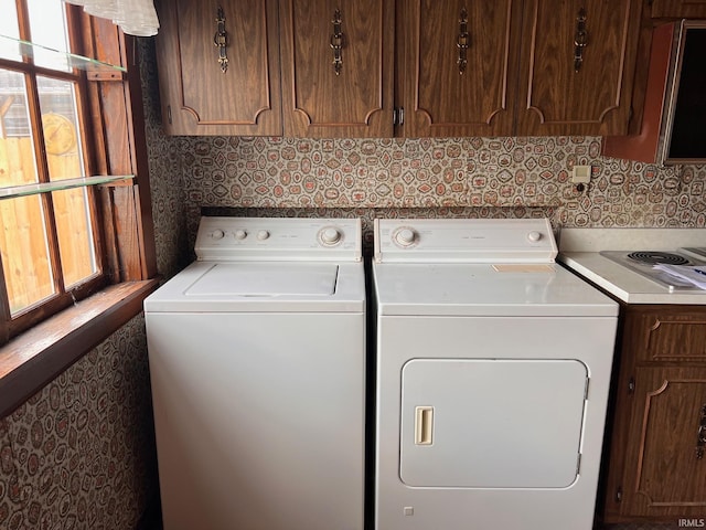 clothes washing area featuring washer and dryer