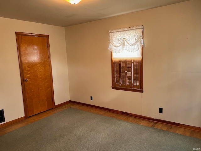 unfurnished room with wood-type flooring