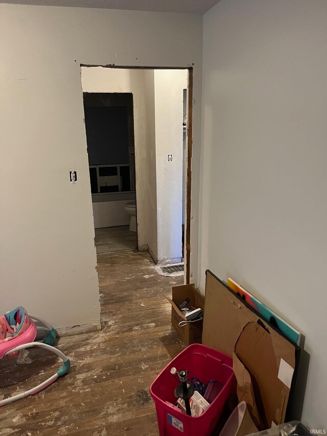 hallway with dark hardwood / wood-style floors