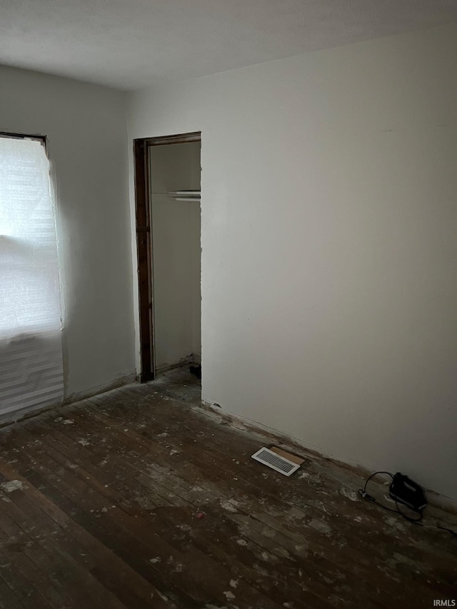 1614 N Johnson St, South Bend, IN 46628 - unfurnished bedroom with hardwood / wood-style flooring and a closet
