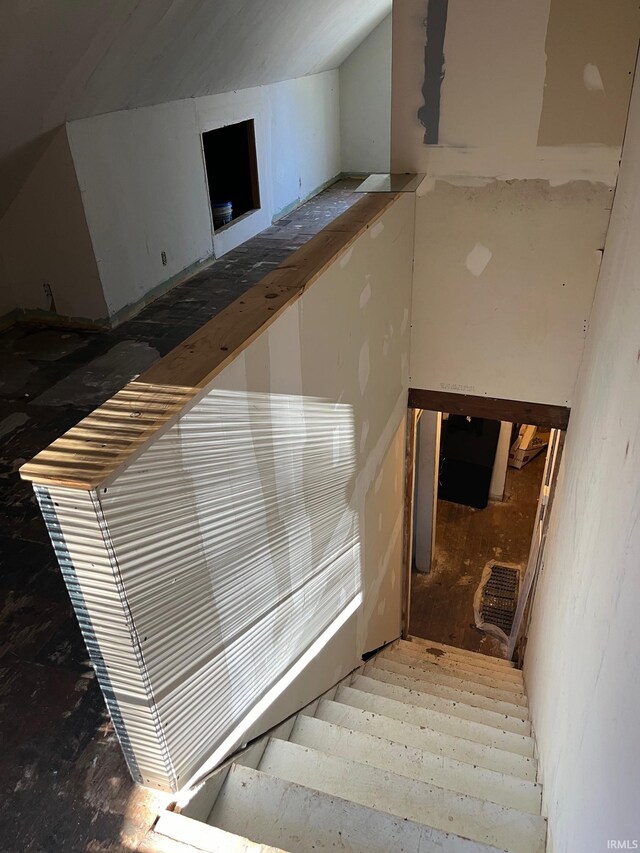 stairway featuring vaulted ceiling