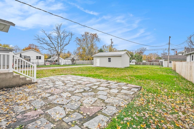 view of yard with an outbuilding and a patio