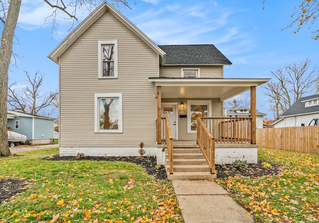 view of front facade featuring covered porch and a front yard