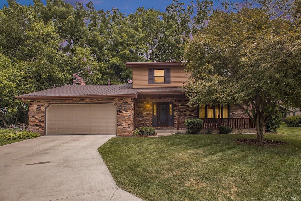 front facade featuring a front lawn and a garage