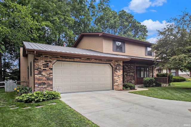 view of front property featuring a garage and a front yard