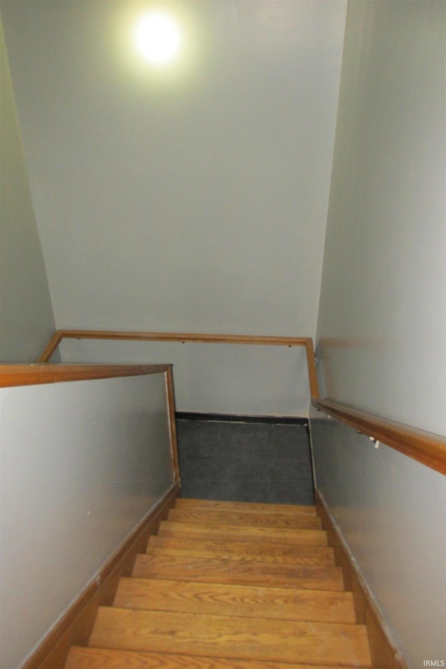 stairway featuring hardwood / wood-style floors