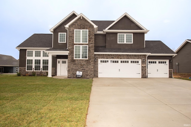 craftsman-style home featuring a garage and a front lawn