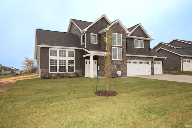 craftsman house featuring a garage and a front lawn