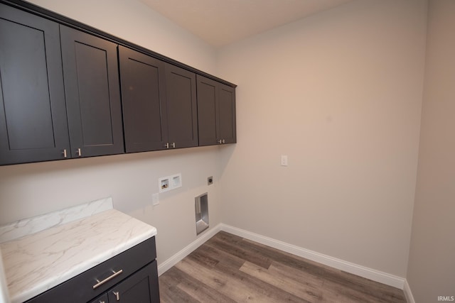 clothes washing area featuring cabinets, hardwood / wood-style floors, hookup for a washing machine, and hookup for an electric dryer