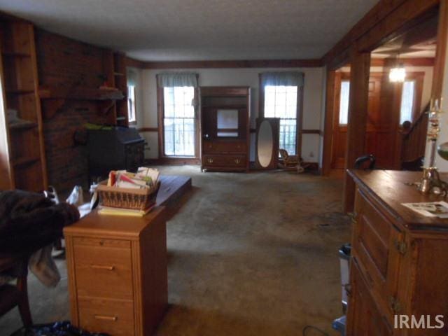 living room featuring carpet and crown molding