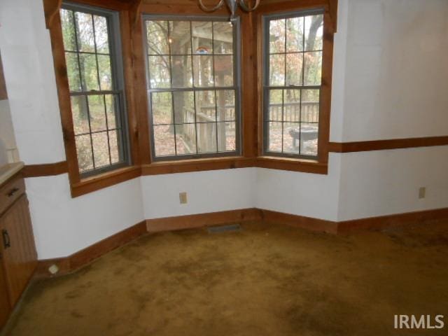 unfurnished dining area with carpet