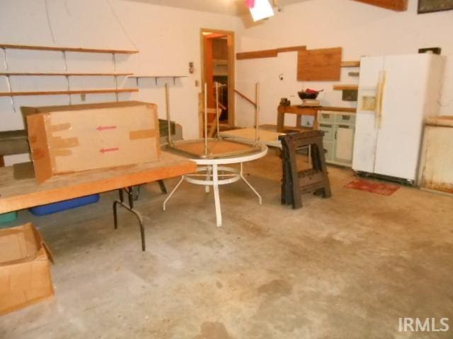 garage with white refrigerator with ice dispenser