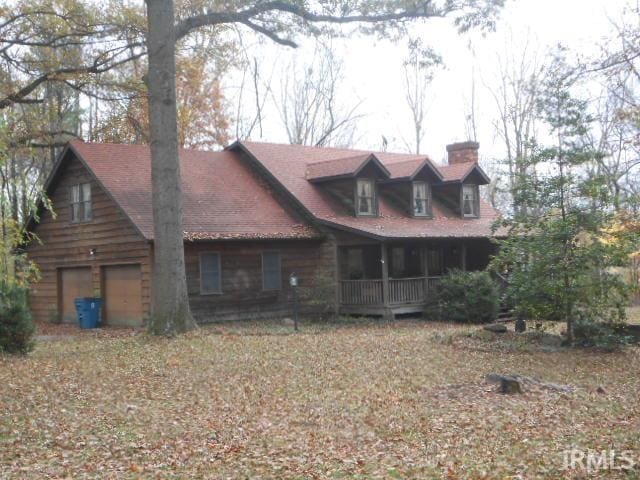 view of front of house with covered porch and a garage