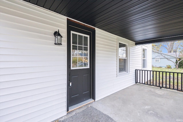 doorway to property featuring covered porch