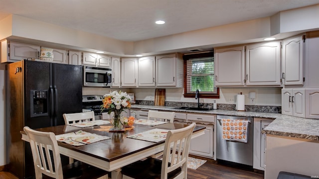 kitchen with decorative backsplash, stainless steel appliances, dark wood-type flooring, and sink