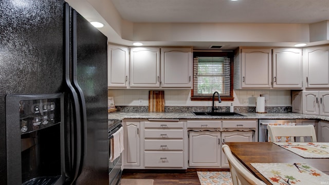 kitchen with decorative backsplash, sink, black appliances, white cabinets, and dark hardwood / wood-style floors