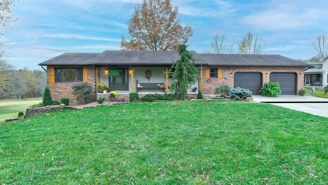 ranch-style home featuring a front lawn, covered porch, and a garage