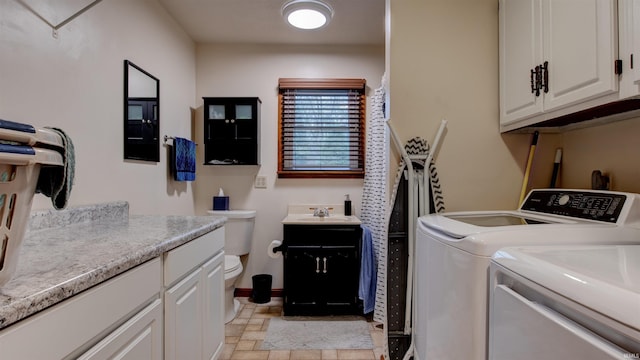 laundry area with separate washer and dryer and sink