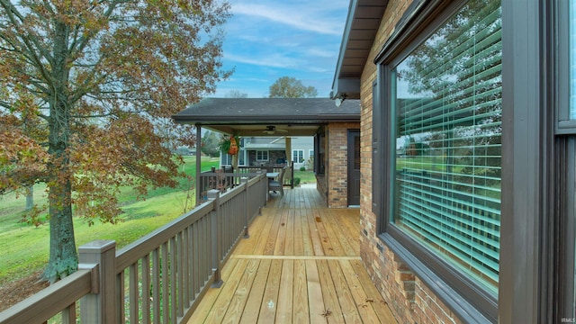 wooden deck featuring ceiling fan