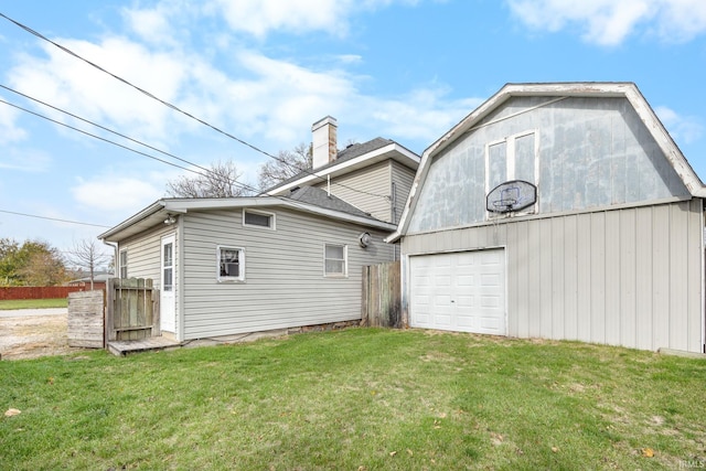 rear view of property with a yard and an outdoor structure