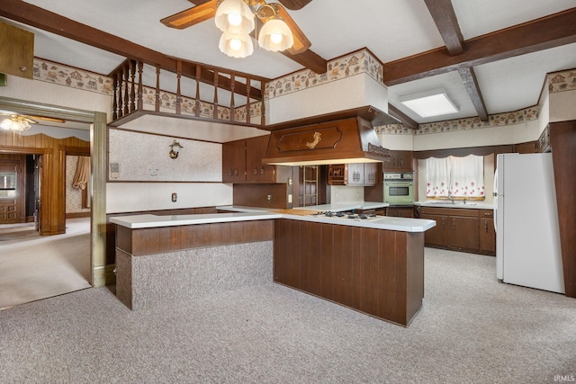 kitchen with kitchen peninsula, light carpet, white appliances, ceiling fan, and beam ceiling