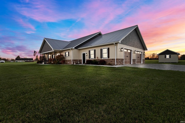 view of front of property featuring a garage and a yard