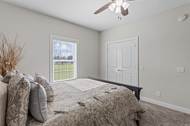 carpeted bedroom with ceiling fan and a closet