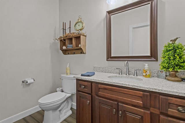 bathroom featuring hardwood / wood-style floors, vanity, and toilet