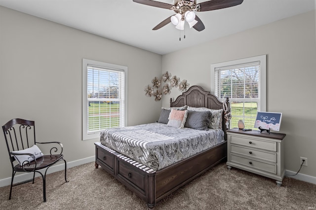 bedroom with ceiling fan, carpet floors, and multiple windows