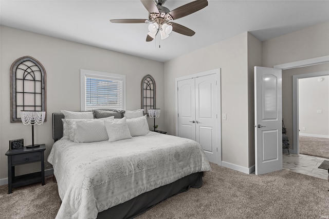 carpeted bedroom with a closet and ceiling fan