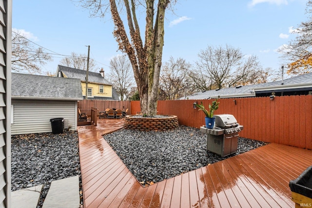 wooden terrace featuring a grill