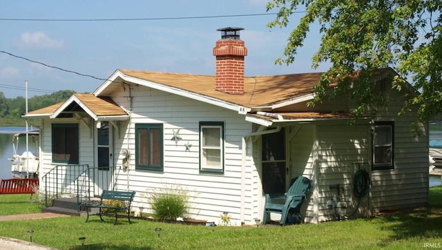 rear view of property with a yard