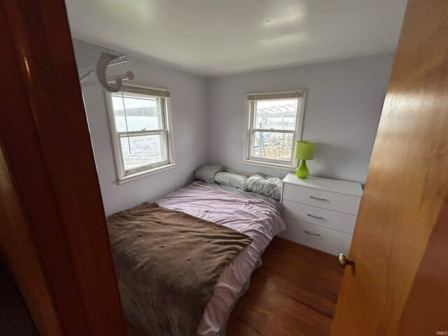 bedroom with dark wood-type flooring