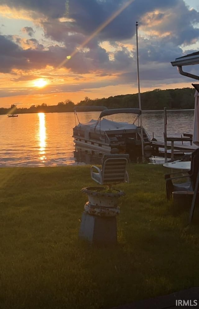 view of dock featuring a water view and a lawn