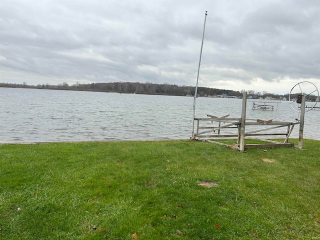 dock area with a yard and a water view