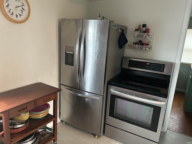 kitchen with stainless steel appliances and light hardwood / wood-style flooring